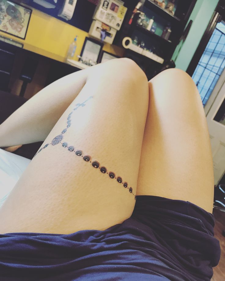 a woman's legs with a tattoo on her left leg and the word love spelled in small letters