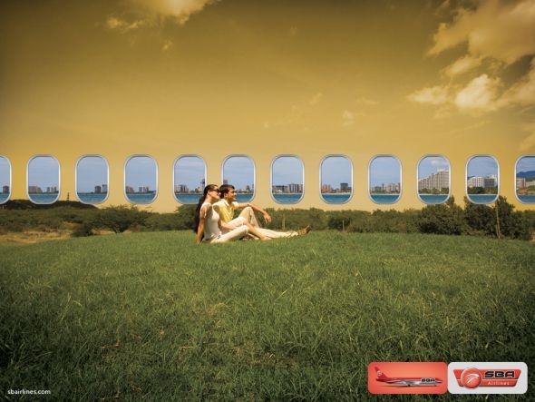 two people sitting on the grass in front of an image of some windows that look like they are flying through the sky