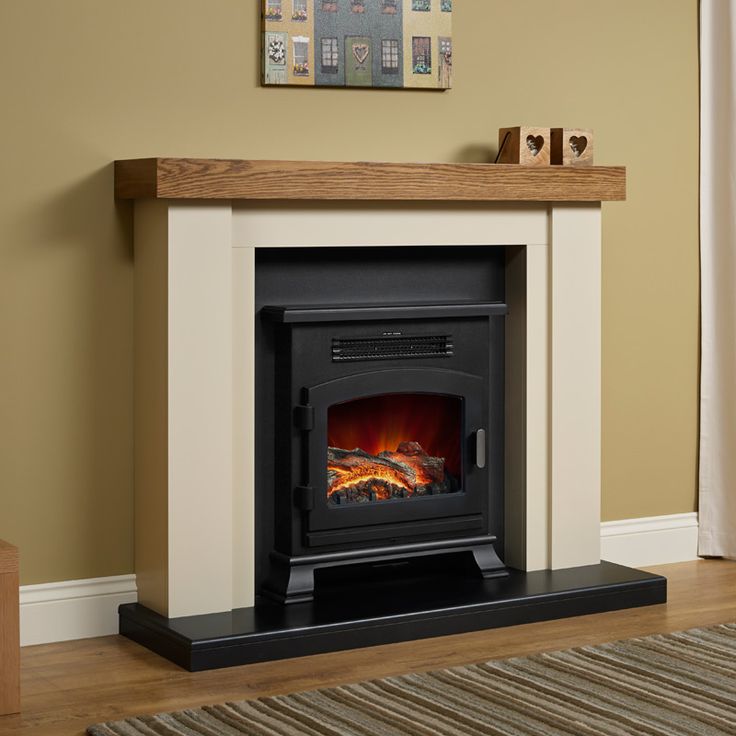 a living room with a fire place in the center and a rug on the floor