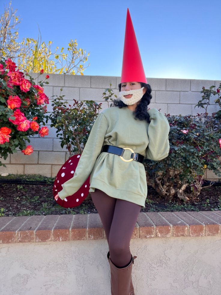 a woman in a gnome costume is posing for the camera