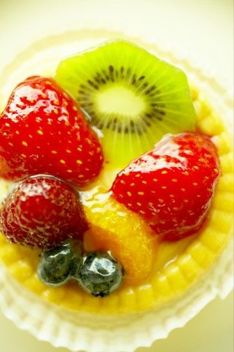 fruit tart with kiwi, strawberry, and blueberries on the top is ready to be eaten