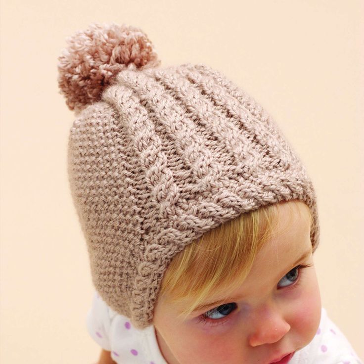 Free Intermediate Knit Hats Pattern For BabyA delicate hat with cable trim makes a darling gift for any tiny tot. Bernat Softee Baby is OEKO-TEX Standard 100 certified, so it's always safe to use. Select your color and let's get you on your way to completing a warm hat that looks priceless. Baby Hat Knitting Pattern, Hat Patterns Free, Baby Knitting Patterns Free, Baby Hats Knitting, Knit Hats, Knitting Supplies, Baby Yarn, Hat Knitting Patterns, Free Knitting Pattern