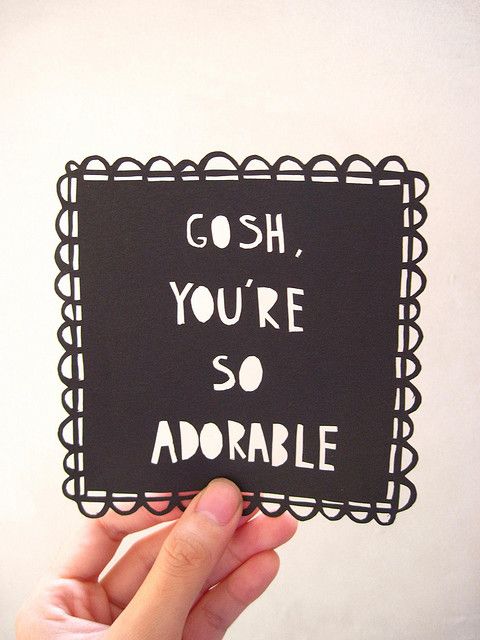 someone holding up a card that says gosh, you're so adorable