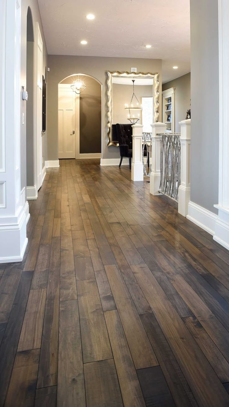 an empty living room with hard wood flooring