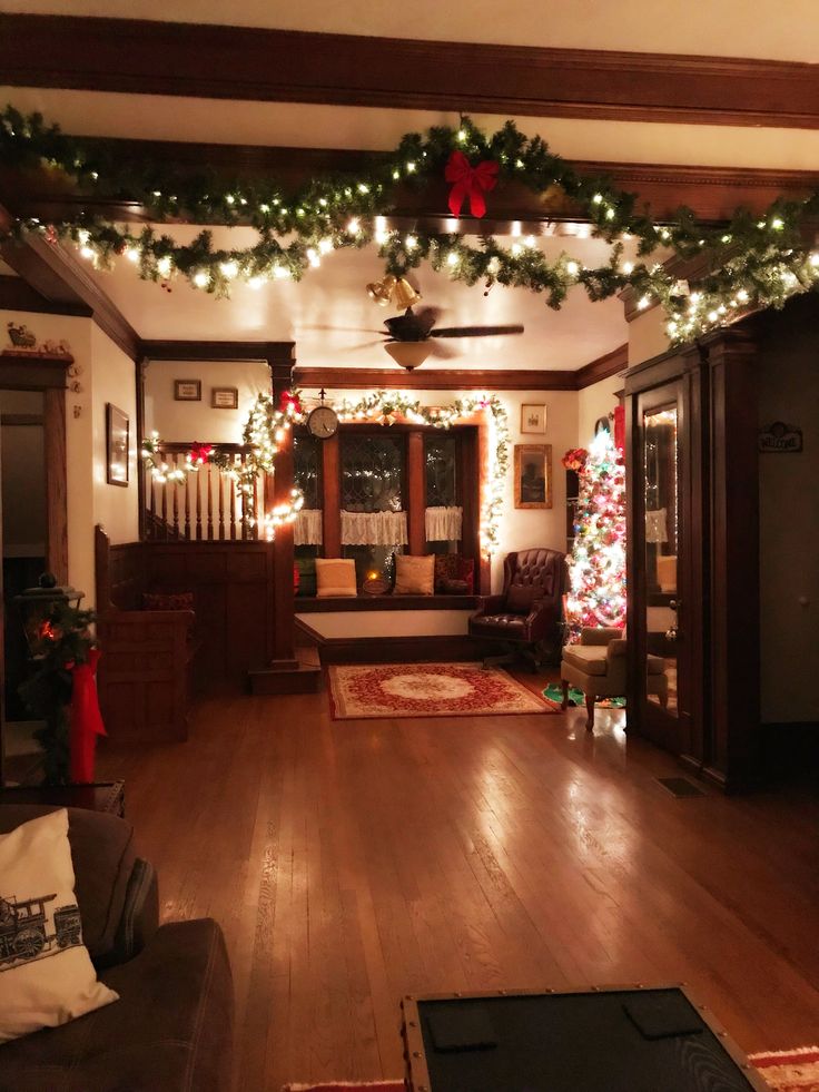 the living room is decorated for christmas with garland and lights