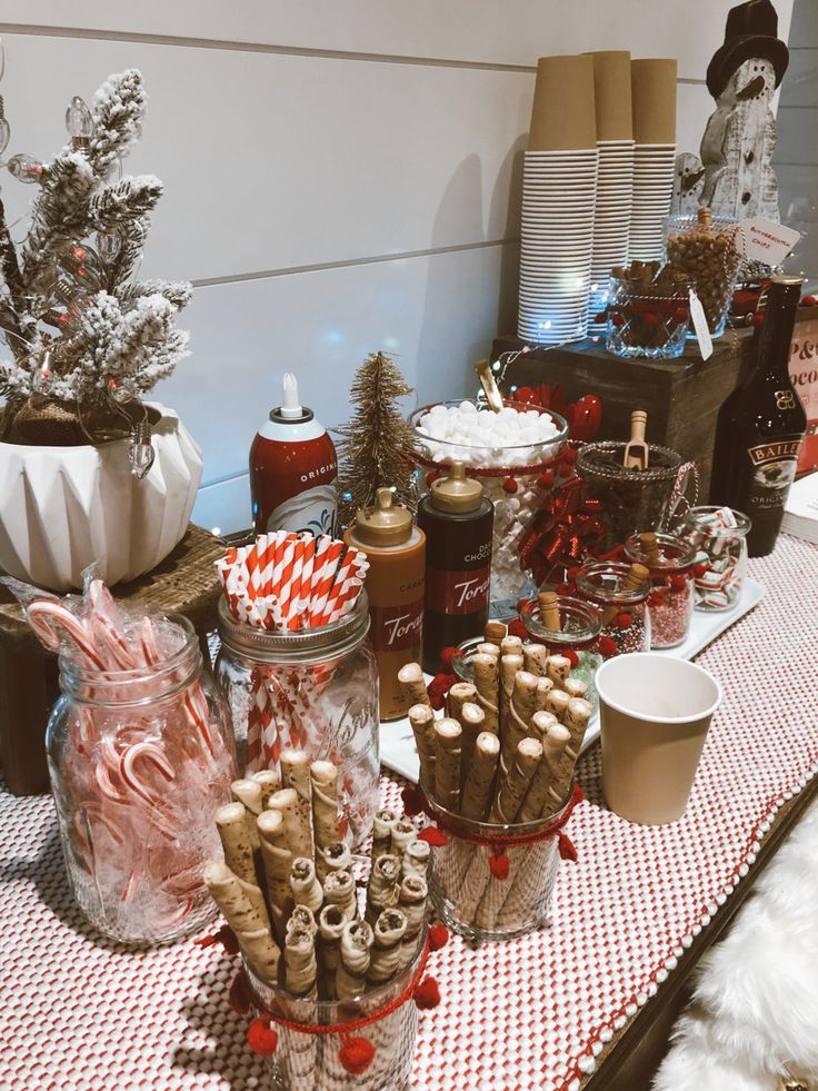 the table is covered with candy canes, cookies and other holiday treats for sale