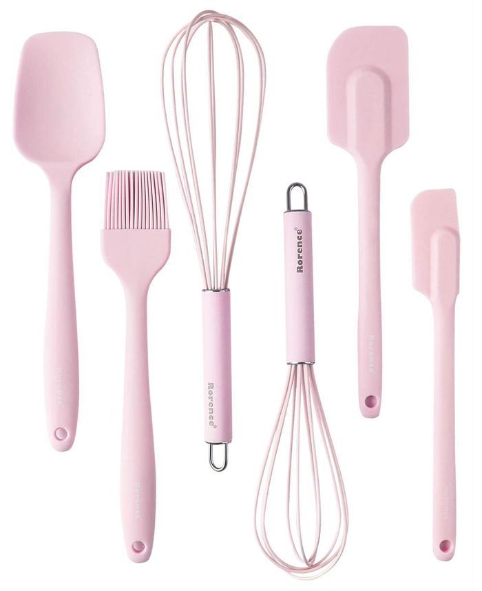 pink kitchen utensils and spatulas on a white background