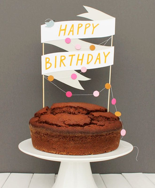 a chocolate cake on a plate with a happy birthday sign