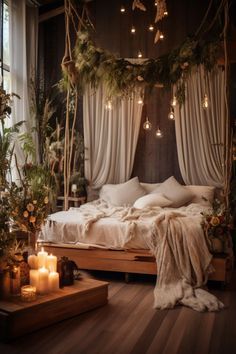 an unmade bed with candles and greenery in the corner, next to a window