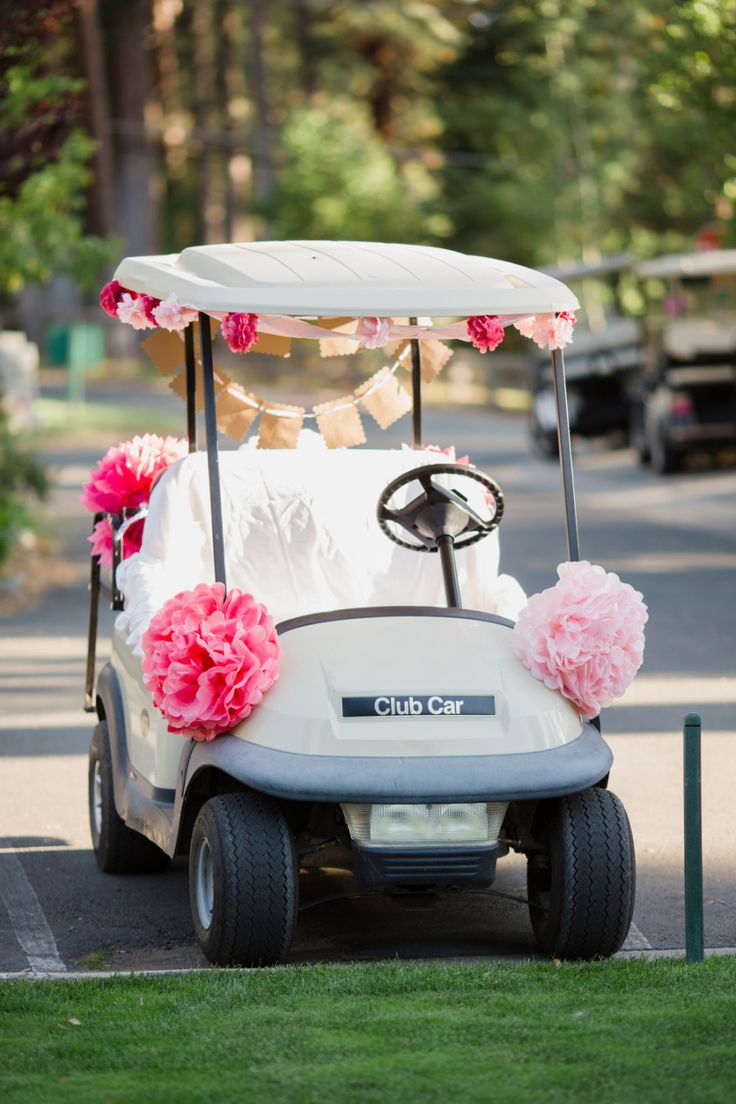 a white golf cart with pink flowers on it