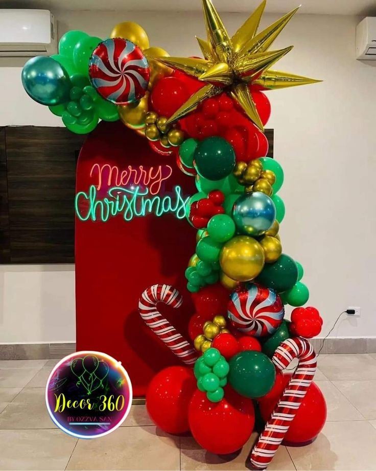 a christmas balloon arch with candy canes and balloons