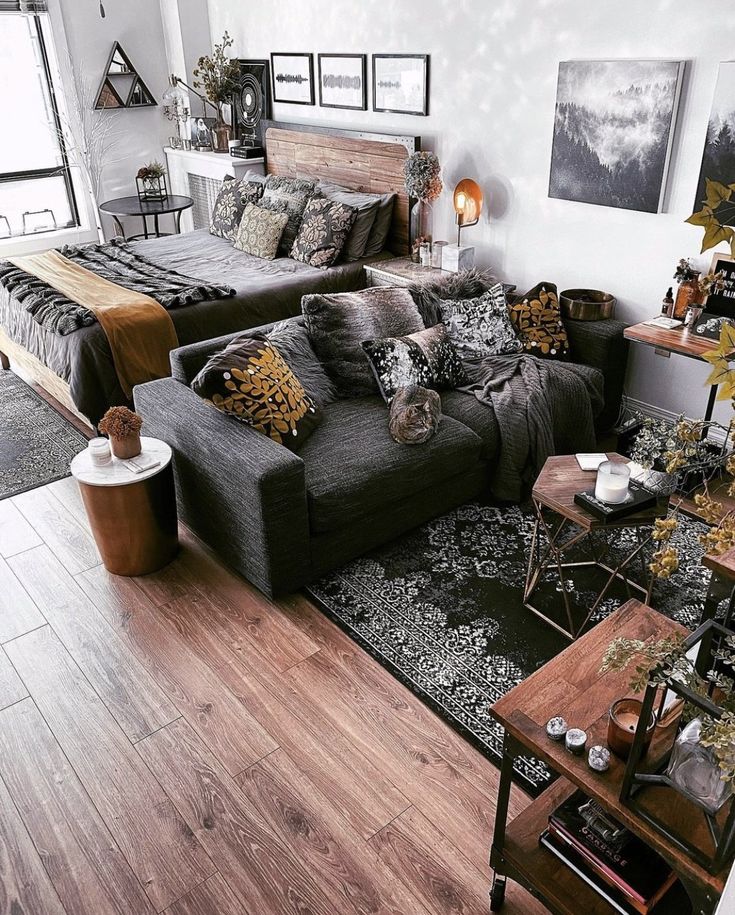 a living room filled with lots of furniture next to a wooden floor covered in pictures