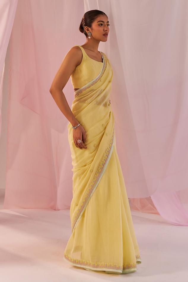 Yellow saree in silk chanderi base and with dori embroidery, sequin and pearl embellishments. Paired with a matching padded square neck silk chanderi sleeveless blouse.
Components: 2
Pattern: Embroidered
Type Of Work: Pearl, Sequin
Neckline: Square
Sleeve Type: Sleeveless
Fabric: Silk Chanderi, Lining: Shantoon
Color: Yellow
Other Details: 
Model Height: 5ft 6inches, wearing size M
Occasion: Puja, Mehendi and Haldi - Aza Fashions Dori Embroidery, Yellow Pearl, Yellow Saree, Yellow Silk, Blouse For Women, Saree With Blouse, Fabric Silk, Blouse Online, Sarees Online