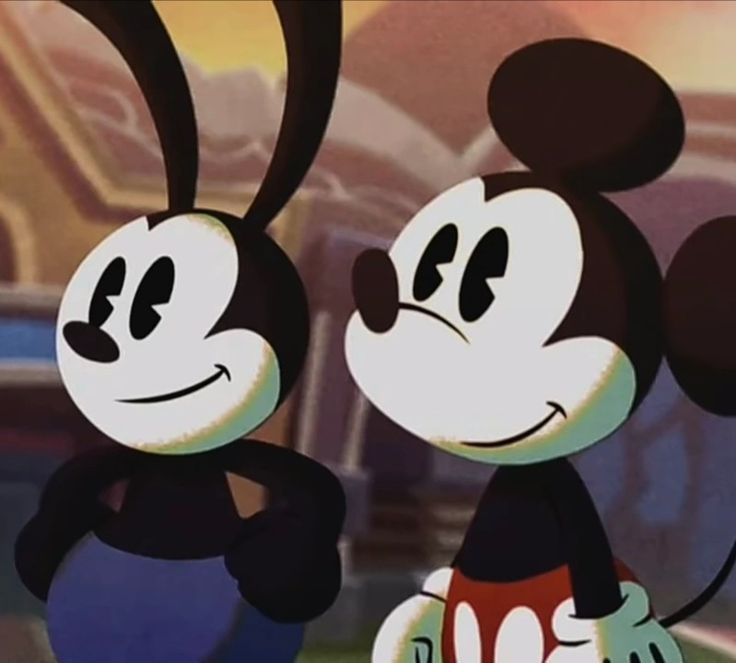 two mickey mouses standing next to each other