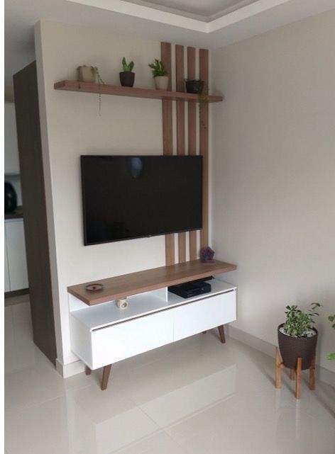 a flat screen tv sitting on top of a white entertainment center in a living room