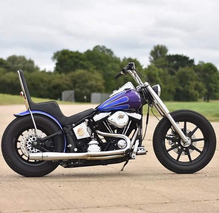 a purple and black motorcycle parked on the street