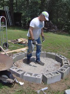 a man is working with cement in the yard