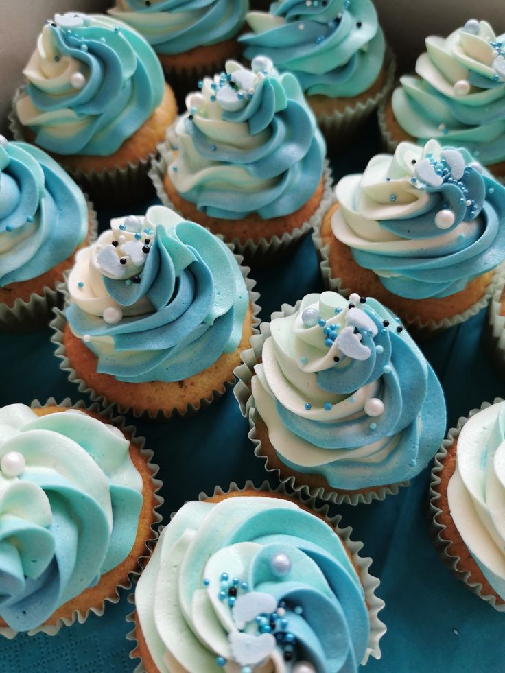 there are many cupcakes with blue frosting on them