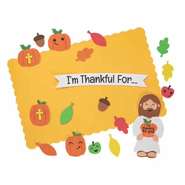 a paper cutout of jesus surrounded by pumpkins and leaves with the words i'm thanksgiving for