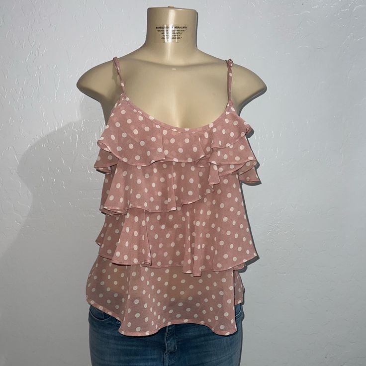 Pink Polka Dot Blouse With Ruffles Brand: Zinga Size Medium New With Tags 100% Polyester Cute Sleeveless Blouse With Ruffles, Cute Polka Dot Top For Spring, Cute Spring Polka Dot Tops, Cute Polka Dot Sleeveless Top, Casual Swiss Dot Blouse, Feminine Polka Dot Tops For Summer, Casual Polka Dot Swiss Dot Top, Feminine Swiss Dot Tops For Summer, Spring Sleeveless Swiss Dot Top