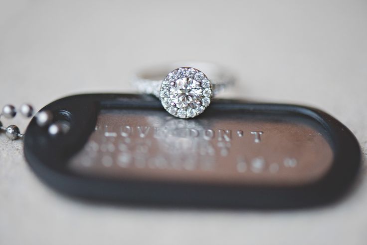 a diamond ring sitting on top of a black tag