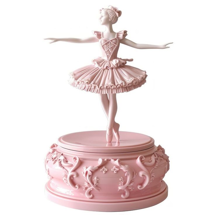 a pink ballerina figurine sitting on top of a pink box with an ornate design