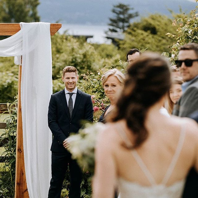 a man in a suit and tie standing next to a woman at a wedding ceremony