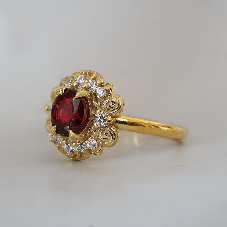 Indulge in timeless romance with the Rosaire spinel ring. Featuring a vibrant spinel center stone in a French-inspired setting, this ring captures and reflects light beautifully, reminiscent of Parisian nights. Crafted with delicate filigree, the Rosaire exudes elegance and vintage charm, making it the perfect symbol of eternal love. Ideal as a gift or a cherished addition to your collection, this stunning ring is a true treasure. All orders come in our Tippy Taste ring box. This ring is handmade and designed in NYC. 14K or 18K solid gold Natural oval red spinel, 5*4mm 12 Natural round diamonds. SI clarity, GH color, 0.1ct total carat weight 1.5mm ring band ** Tippy Taste Heirloom Collection is made to order. Please allow 3-4 week turnaround time. Shipping:Domestic: Free shippingInternatio Timeless Ruby Ring With Halo Setting As A Gift, Elegant Ruby Wedding Ring With Halo, Heirloom Ruby Ring With Accent Stones In Yellow Gold, Timeless Ruby Ring With Rose Cut Diamonds For Wedding, Elegant Ruby Ring With Rose Cut Diamonds For Promise, Elegant Cluster Ring With Accent Stones For Proposal, Heirloom Gold Ruby Ring With Center Stone, Elegant Ruby Ring With Halo Design, Heirloom Ruby Wedding Ring In Yellow Gold