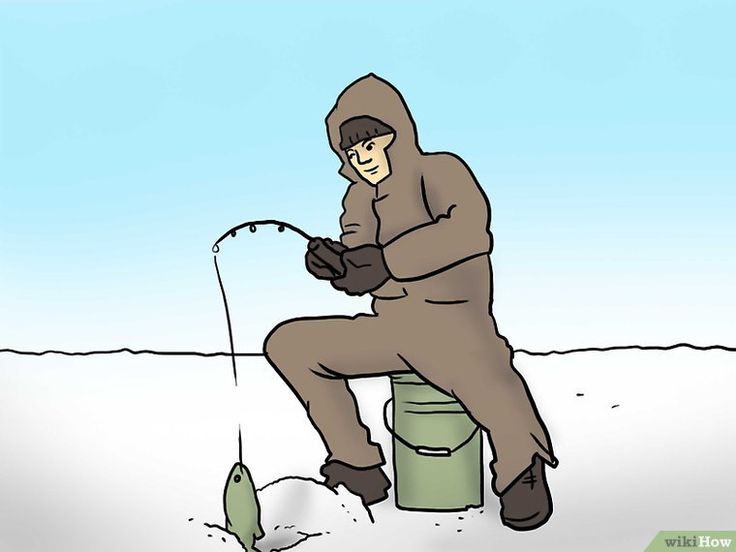 a man sitting on top of a bucket fishing