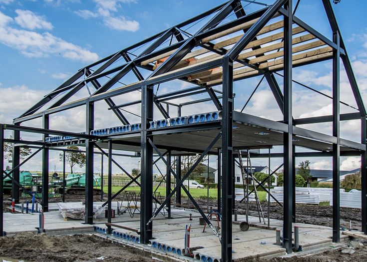 a building being constructed with metal framing and wooden roof