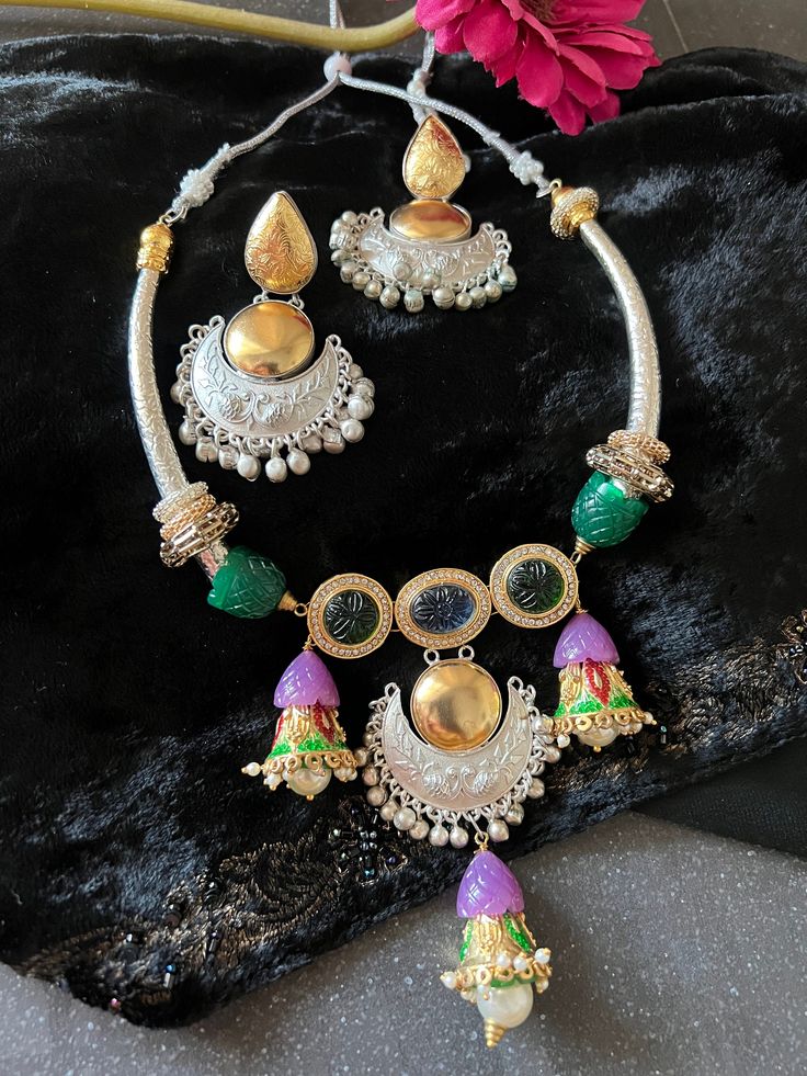 Be Classy, Be Beautiful!! The gorgeous necklace and exclusive earrings are beautifully handcrafted by our skilled Indian craftsmen from Jaipur in dual-tone polish. Notice the beautifully carved stones and Kundan Embellishments.   Material: Brass with gold and silver plating The length of the earrings is 7 cm The width of the earrings is 5 cm The weight of the earrings is 30 grams  The drop length of the necklace is 8 inches  Necklace comes with adjustable Dori. Temple Jewelry Sets With Matching Earrings For Festive Occasions, Traditional Festive Necklaces With Matching Earrings, Festive Fusion Style Jewelry Sets, Festive Jewelry Sets With Matching Earrings For Diwali, Fusion Style Hand Set Jewelry For Festivals, Dual-tone Pendant Jewelry For Festivals, Elegant Multicolor Dual-tone Jewelry, Festive Chandbali Necklaces With Matching Earrings, Multicolor Jewelry Sets With Intricate Design For Celebration