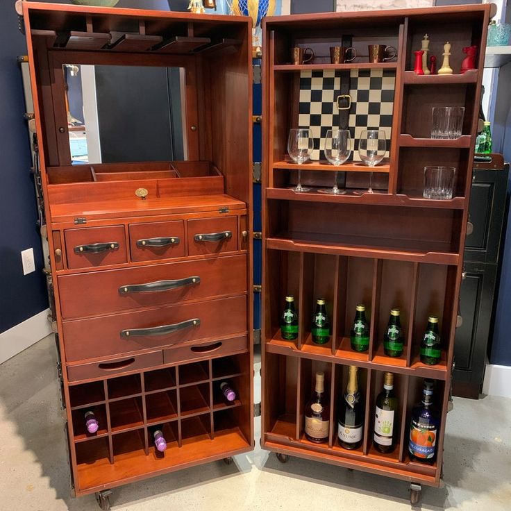 two open wooden shelves with bottles and glasses on them, one has a chess board in it