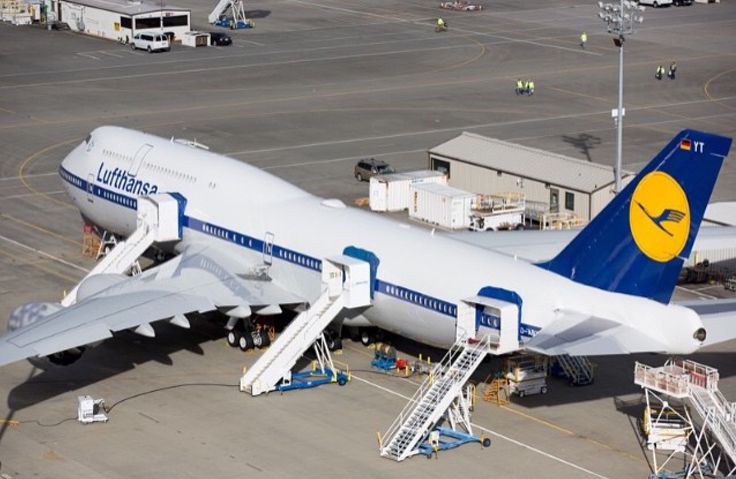 an airplane is parked on the tarmac with stairs leading up to it's door