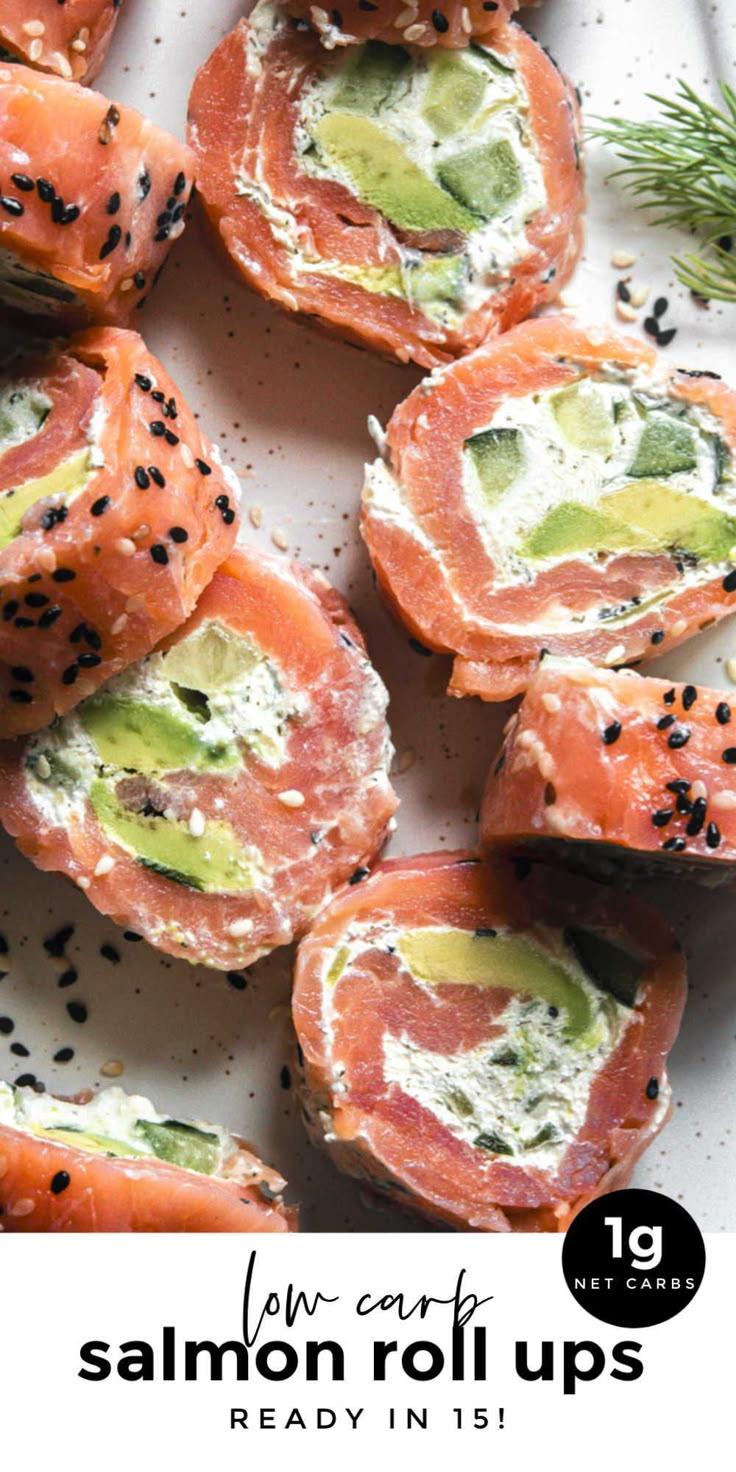 several pieces of sushi on a white plate with black sesame sprinkles