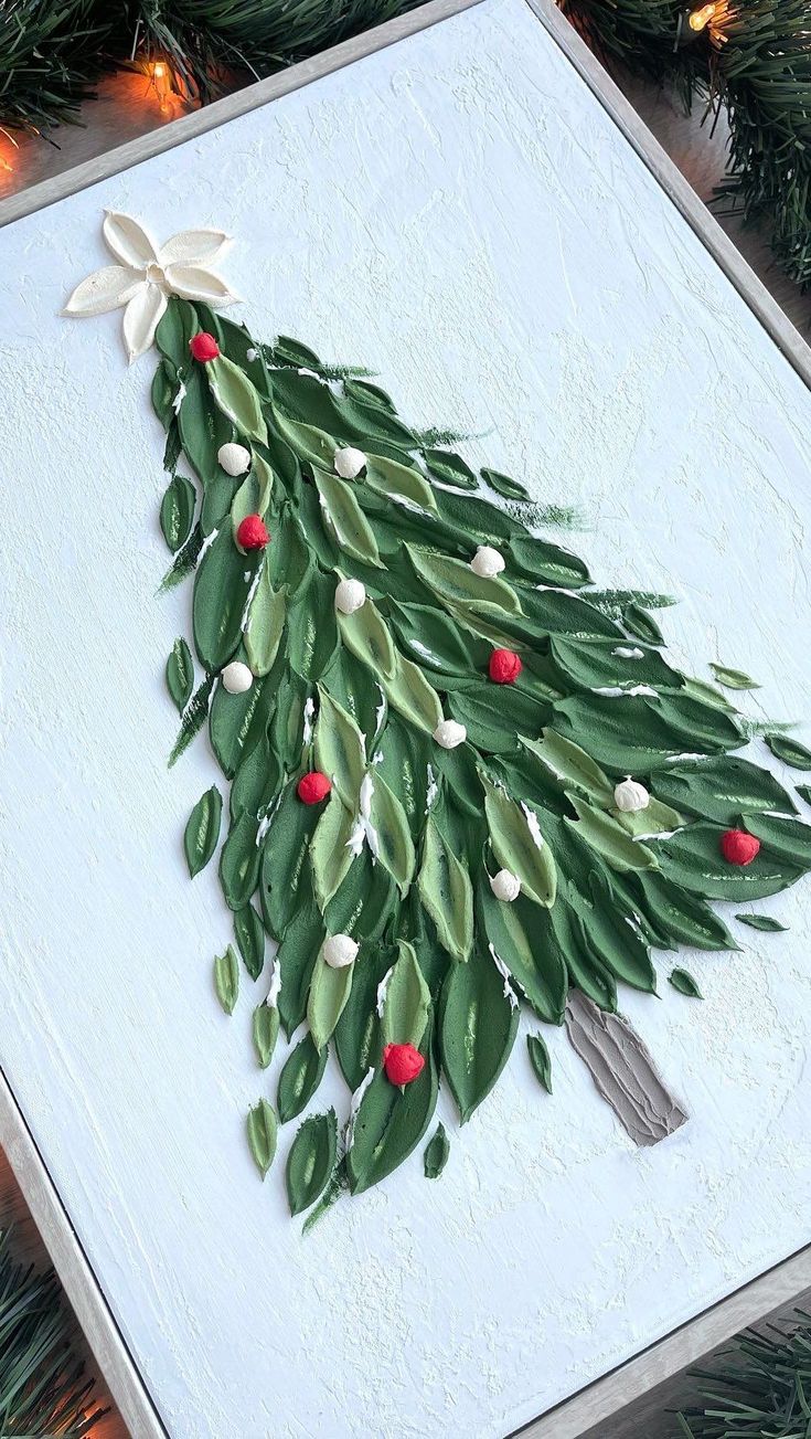 a christmas tree made out of green leaves and red berries is displayed on a card