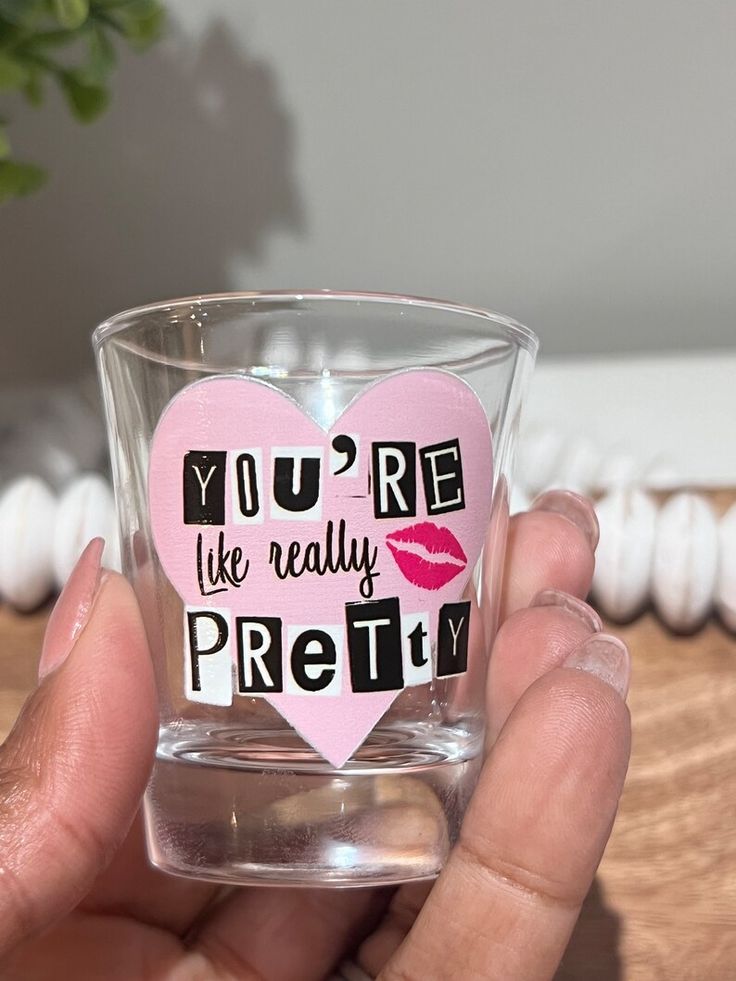 someone holding up a shot glass with the words you're like really pretty on it