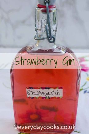 a bottle of strawberry gin sitting on top of a table