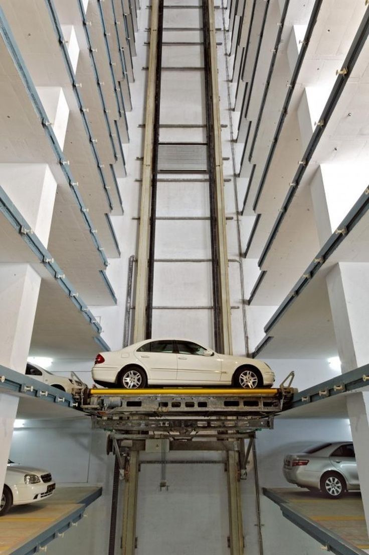 a car is parked in the middle of a parking garage