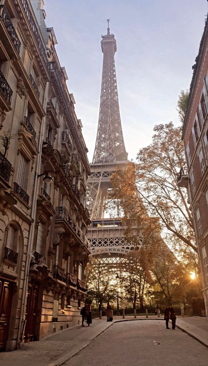 the eiffel tower towering over other buildings in paris, france at sunset or sunrise