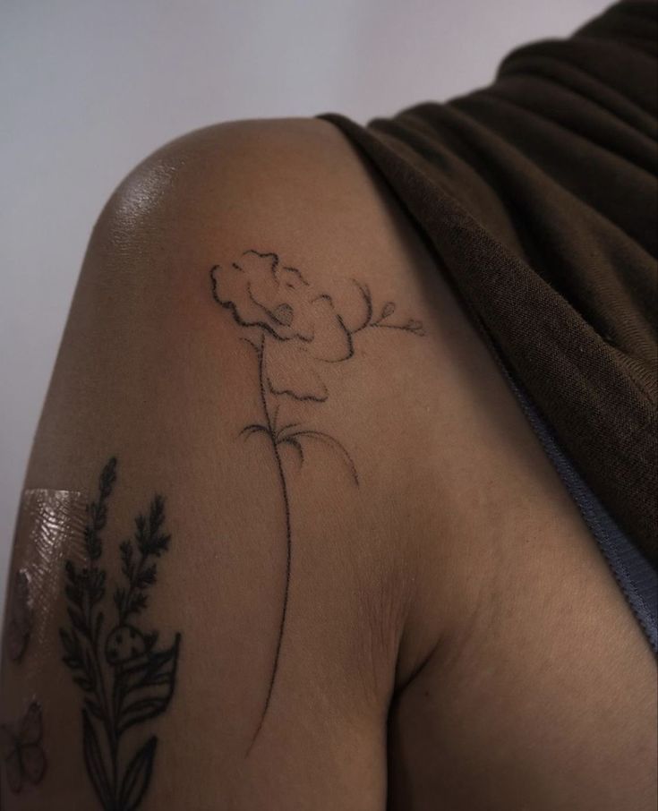 a woman with a flower tattoo on her arm