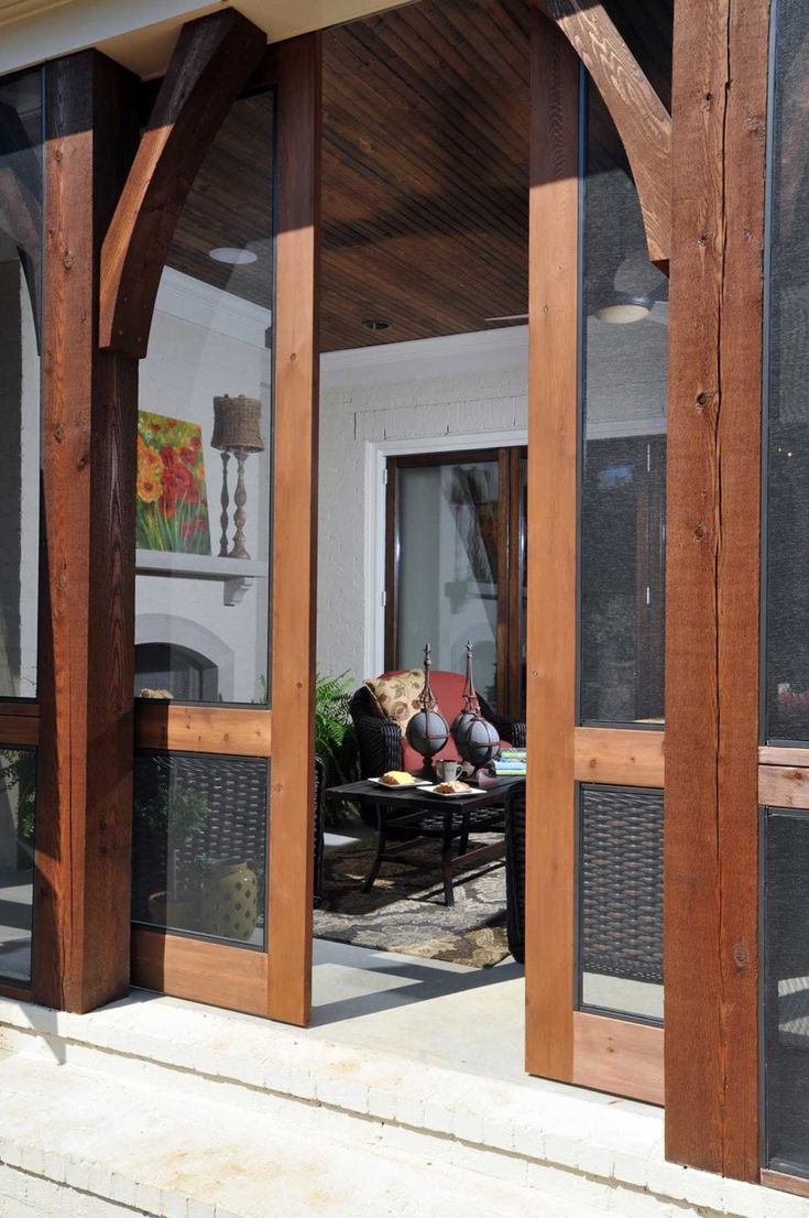 an open patio door leading into a living room and dining area with wood trimming