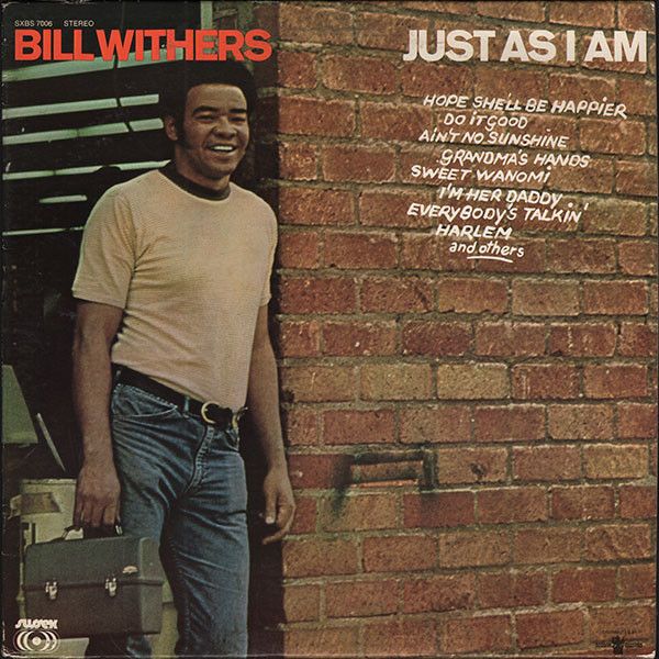 the album cover for bill wither's just as i am, which features a smiling man leaning against a brick wall