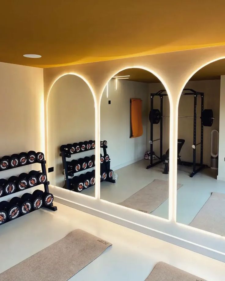 a gym with exercise equipment and mirrors