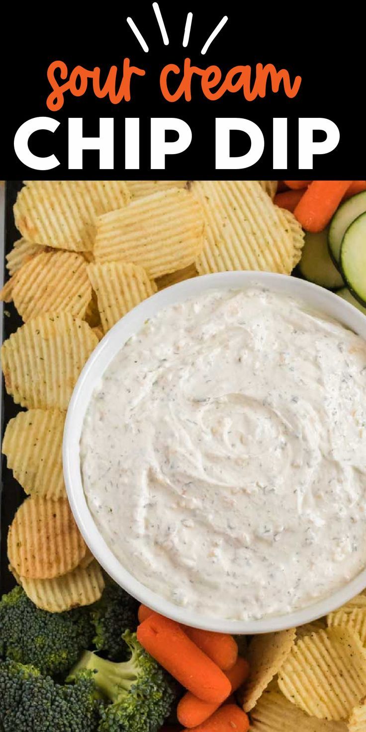 a bowl of dip surrounded by vegetables and crackers with the words sour cream chip dip above it