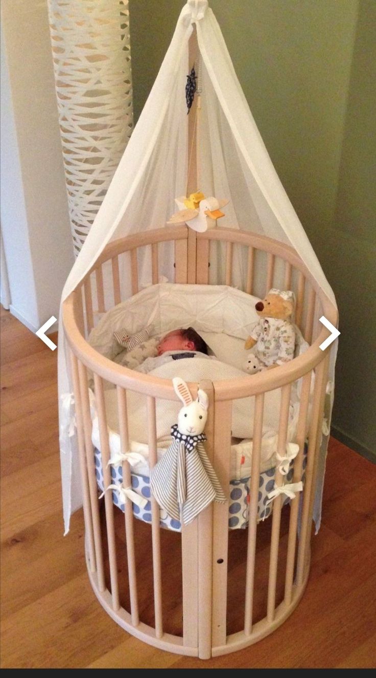 a baby crib that is on the floor with some toys in it's corner