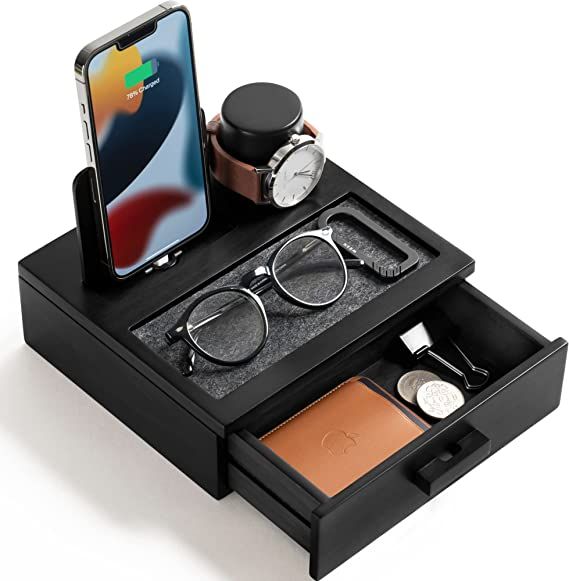 an iphone is sitting on top of a black box with glasses and other items in it