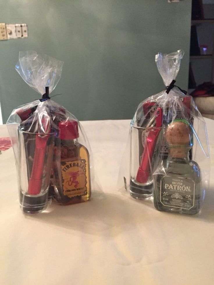 two wine bottles wrapped in plastic and sitting on top of a table next to each other