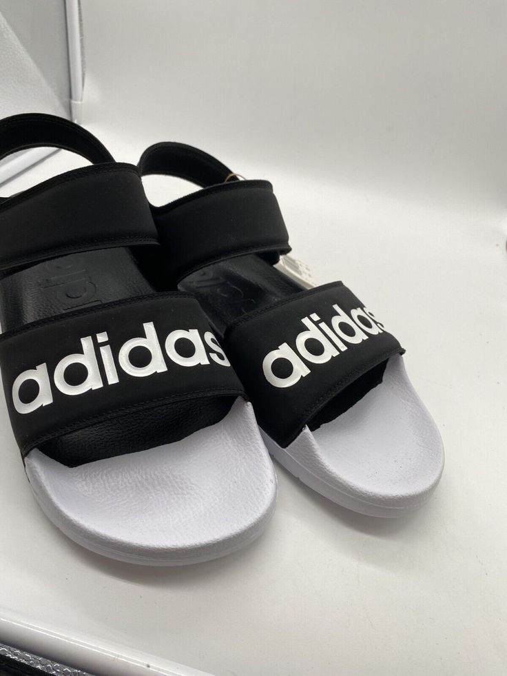 Summer Slide Sandals With Logo Print, Summer Open Toe Sandals With Logo Print, Sports Slides With Adidas Logo And Open Toe, Sports Open Toe Slides With Adidas Logo, Open Toe Adidas Slides For Sports, Adidas Logo Synthetic Slides For Streetwear, Black Adidas Logo Sandals, Summer Black Adidas Sandals, Casual White Adidas Sandals