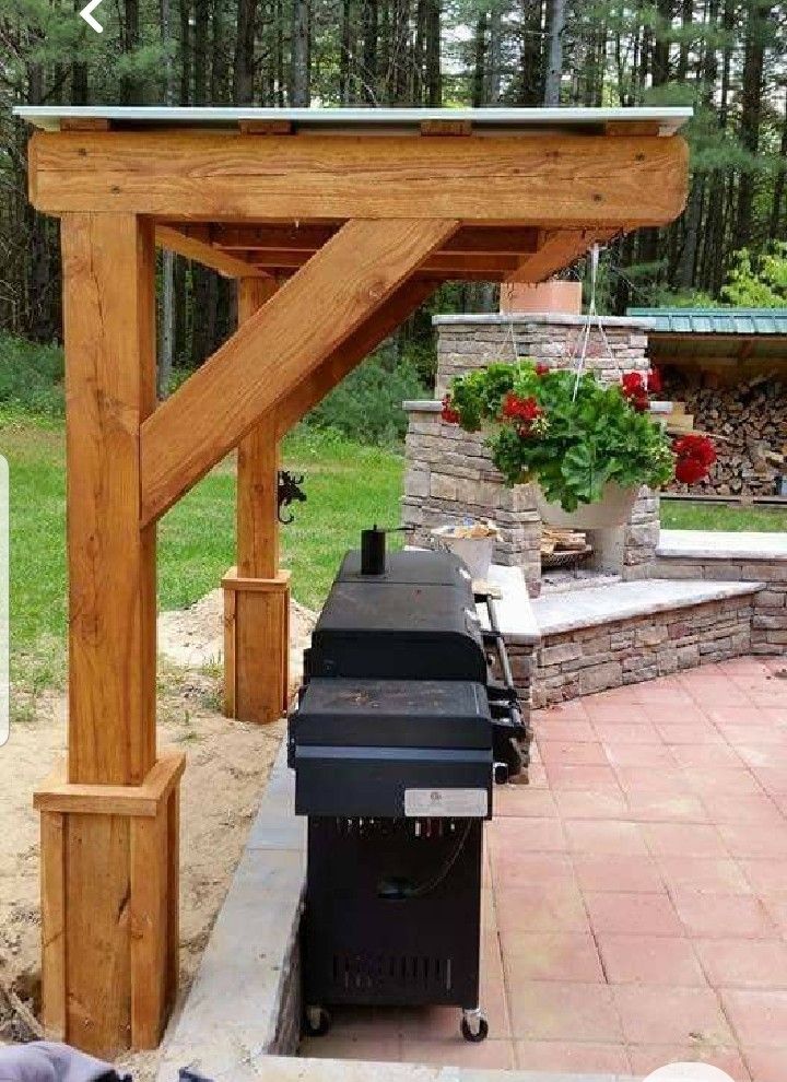 an outdoor bbq and grill area in the backyard