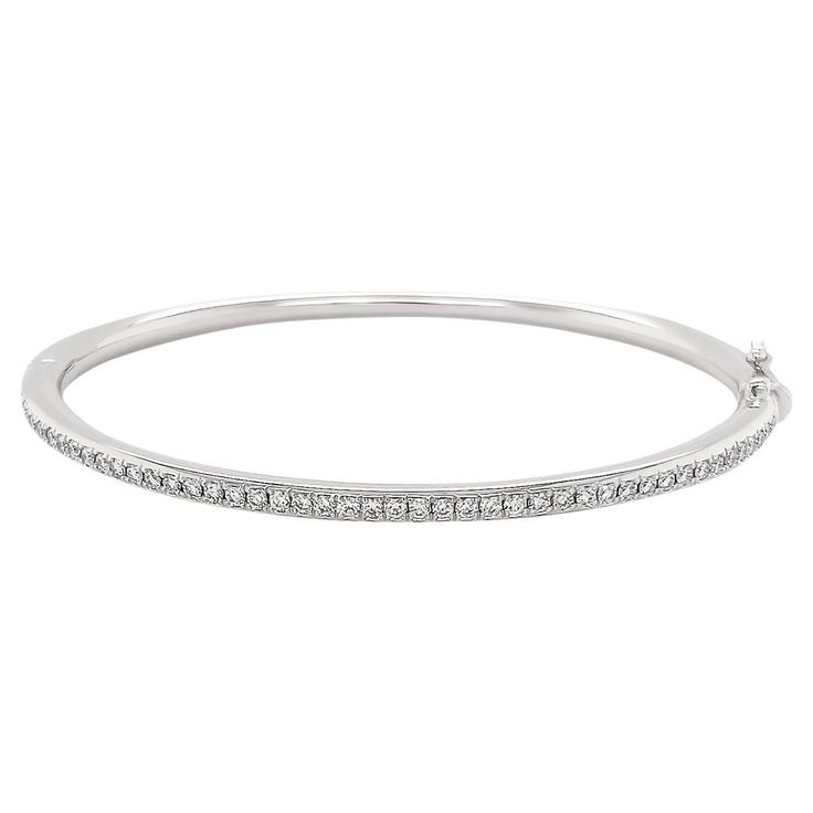 Elevate your elegance with this exquisitely made oval bangle crafted from luxurious 18k white gold. The sleek, contemporary design is adorned with a shimmering array of natural diamonds, which are meticulously set to enhance their brilliance. The oval shape ensures a sophisticated, graceful fit on the wrist, making it a versatile piece that transitions effortlessly from day to night. 18k White Gold Diamonds - .72 cts Oval Bangle, Slim Aarons, Diamond Bangle, White Gold Diamonds, Natural Diamonds, Contemporary Design, Bangle Bracelets, Jewelry Bracelets, Bangles